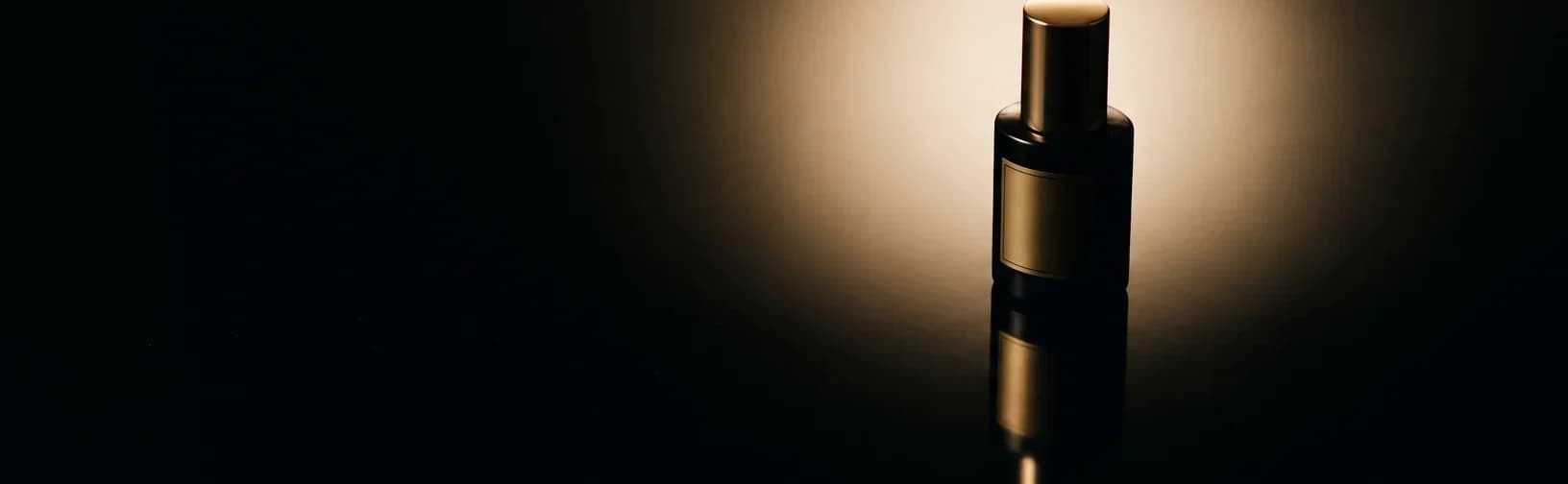 A single foundation bottle on a glossy black vanity under a soft glow